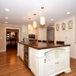 island, painted island, walnut countertop, columns, mirror doors