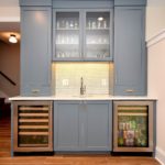 Blue custom cabinets at wet bar, hutch and glass doors.