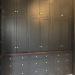 Dark gray painted custom cabinets, flush inset with barrel hinges and walnut counter